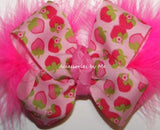 Pink hair bow with strawberry pattern on a white background
