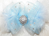 Light blue bow with a rhinestone center on a white background