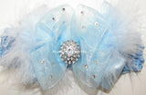 Blue bow with rhinestones attached to a crochet headband