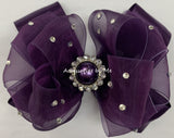 Plum Organza Satin Hair Bow with large Center Plum Rhinestone Accent. Bow attached to a choice of a clip or headband.