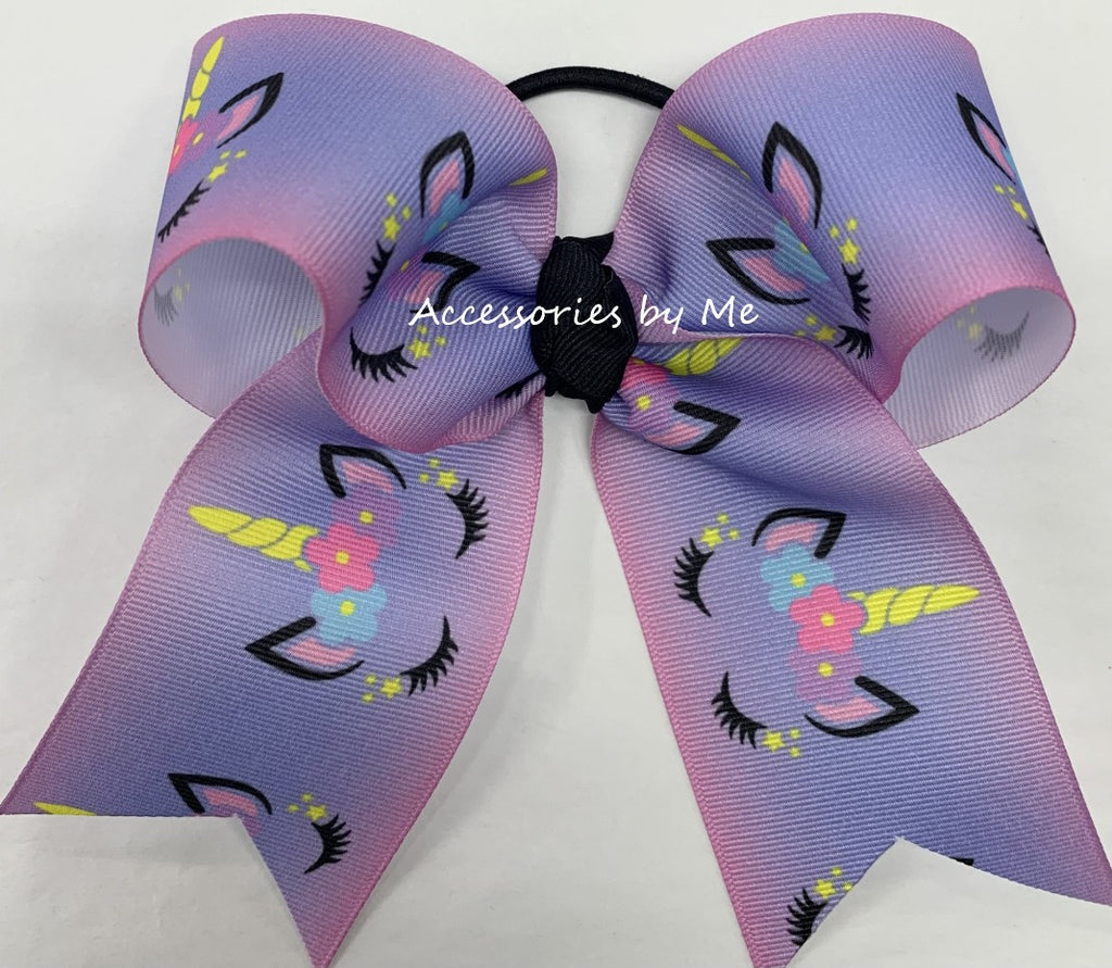 Large purple ombre hair bow with unicorn designs on a white background