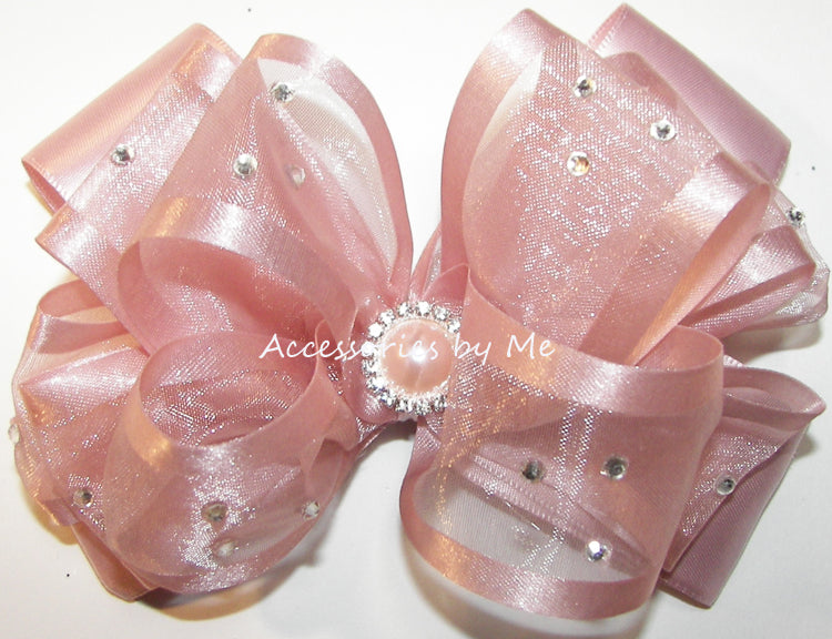 Glitzy Blush Pink Hair Bow, Embellished with Clear Rhinestones and a Center Blush Pink Pearl Rhinestone. Hair Bow attached to choice of Hair Clip or Head Band